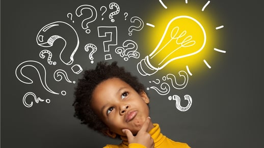 thinking-child-boy-on-black-background-with-light-bulb-and-question-picture-id1252494221